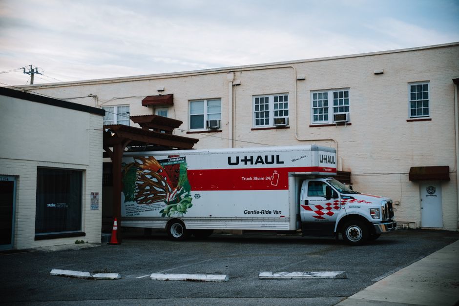 Large moving truck parked outside a beautiful residential home ready for loading